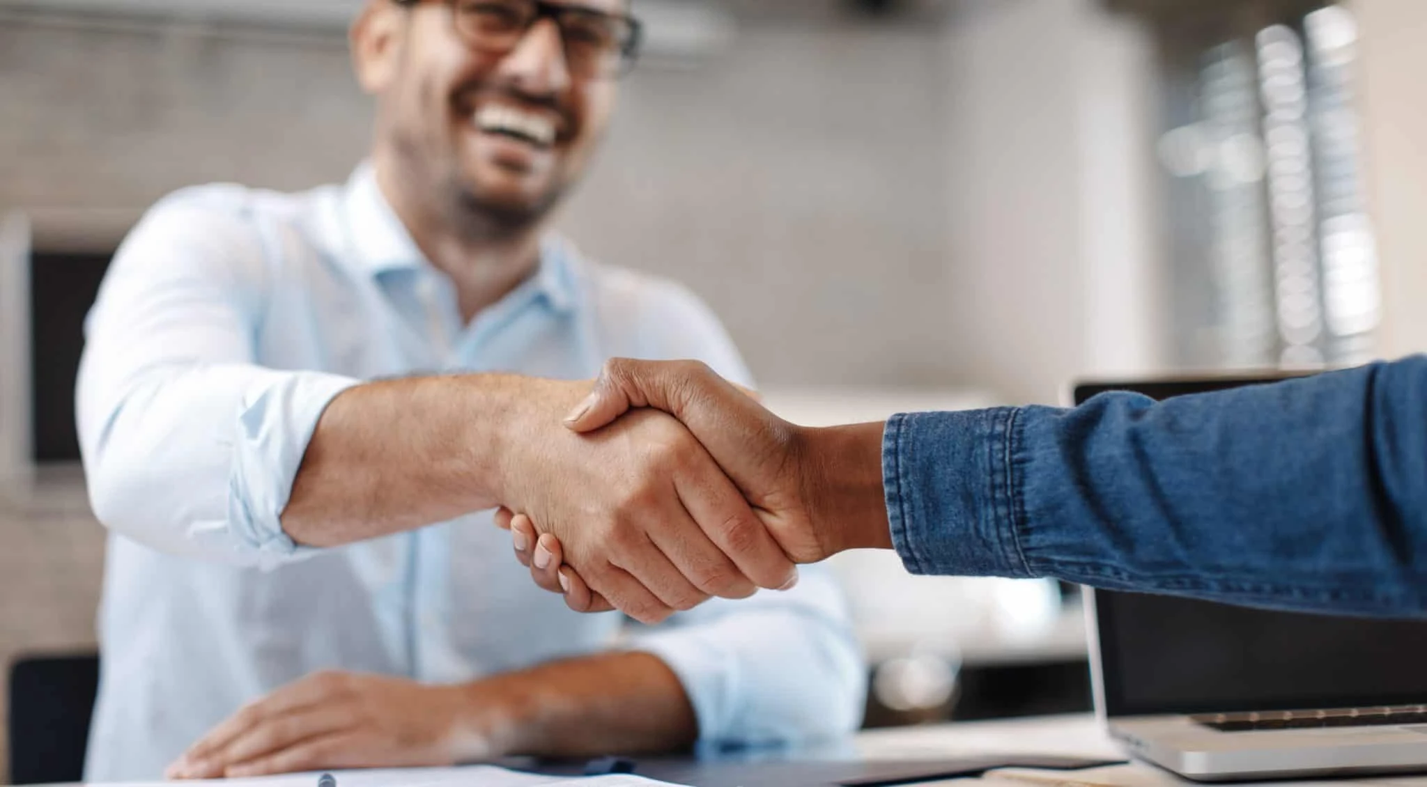 people smiling and shaking hands